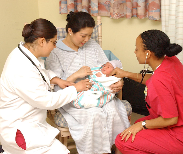 Us Navy 030512 N 0000 W 001 Hospital Corpsman Adoracion Samano And Navy Nurse Corps Officer Lt. Rhonda Hinds Assist Lt.Cmdr. Kenneth R. Spurlock^Rsquo,S Wife On The Maternal Newborn Ward Of U.S. Naval Hospital, Yokosuka, Japan